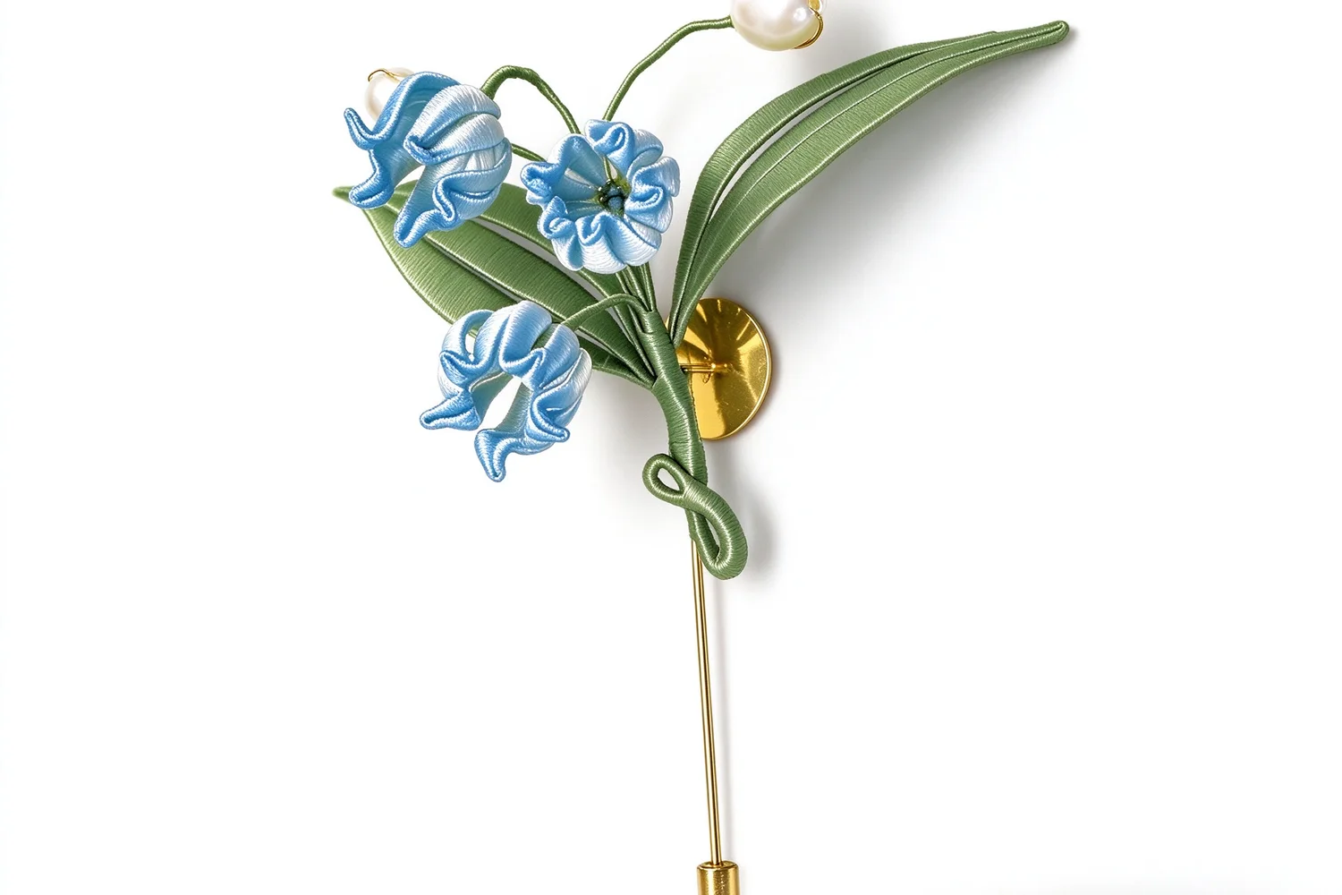 A lily of the valley silk flower piece photographed on a plain white background
